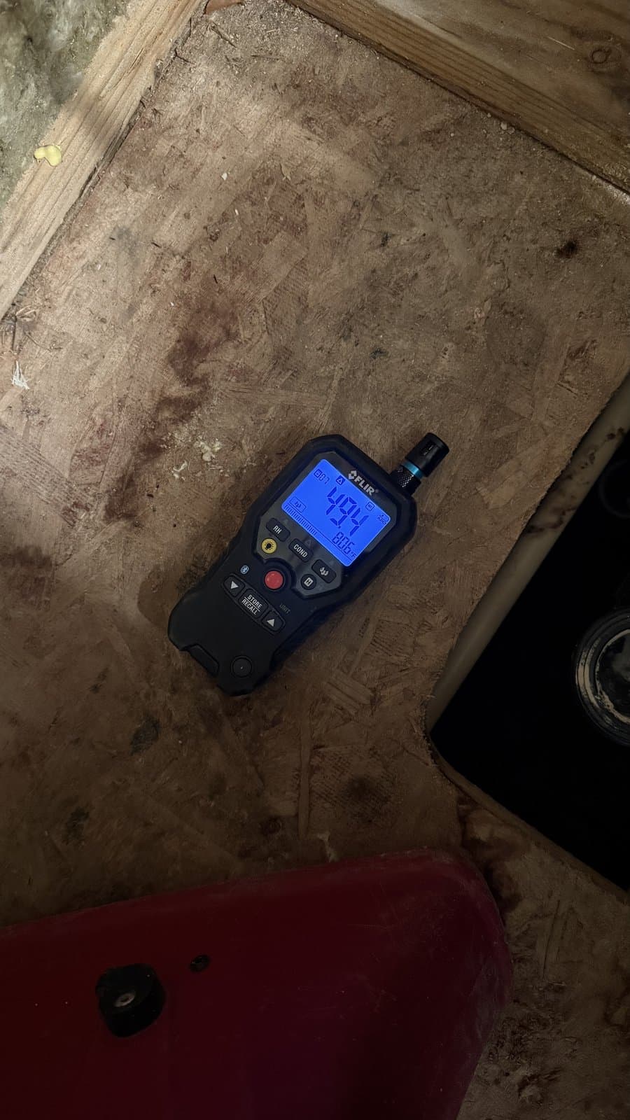 Technician using a moisture meter on a job site