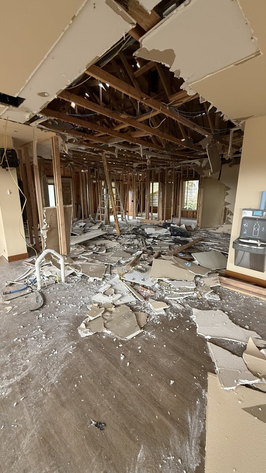 Room with ceiling collapse and debris on the floor